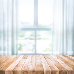 Empty of wood table top on blur of white curtain with window view background