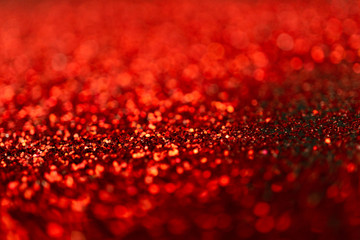 Red glitter texture abstract background on black background.