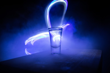 Club drink concept. Tasty alcohol drink cocktail tequila with lime and salt on vibrant dark background or glasses with tequila at a bar