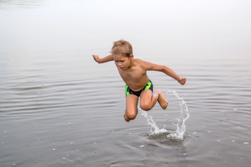 boy  bathe in the river, flies out of the water