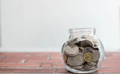 Saving money for a good future for business and for family. Coins inside a jar. Money inside a jar