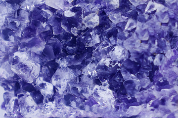 Background made of mineral. Lilac amethyst crystal surface, close up