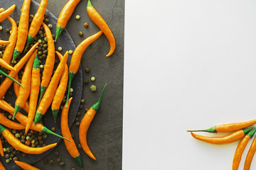 Hot orange pepper. Chilean pepper on a black.