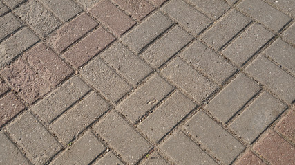 Old grey concrete tiles on the road, pattern texture background for design.