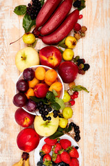 Flat lay of fruits over white wooden background, top view. Vegetarian, vegan, dieting, clean eating, weight loss ingredients.  Summer fruit food background. Copy space.