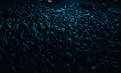 Concert crowd partying to the music performance on stage