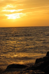 Sun set on a sea with orange sky