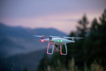 Naklejka na ściany i meble Flying drone at sunrise in the mountains_2