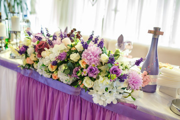 View of the served for decorated wedding dinner table. in elite restaurant with .Beautiful flowers