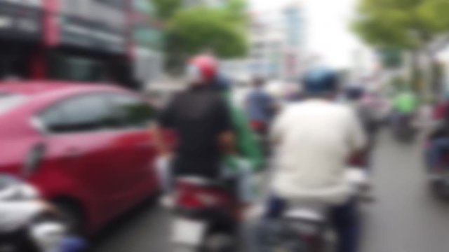 Blurred footage of transport in Ho Chi Minh. Travel in Ho Chi Minh city by a motorbike. Royalty high-quality free stock footage of slow moving traffic with lots of motorcycles, motorbike, bus, car