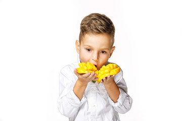 handsome boy in a white shirt is eating a mango
