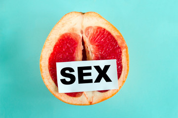 top view ripe juicy grapefruit  with note sex isolated on a blue background