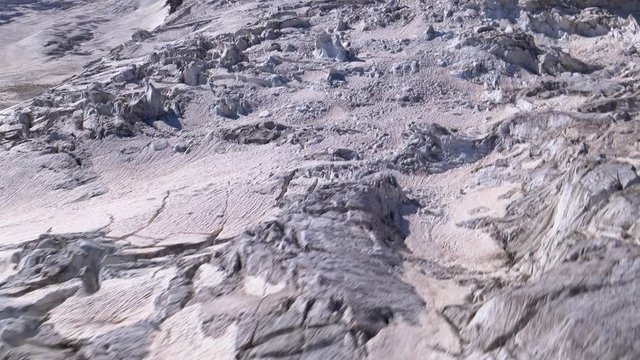 Aerial low fast flight over glacier crevasses and massive seracs. Monte Rosa area, Zermatt, Switzerland