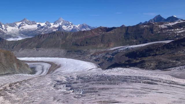 Aerial rearward shot over the Grenzgletscher glacier, looking toward the Gornergrat. Zermatt area, Switzerland