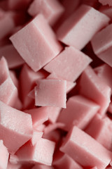 Macro shot of cut sausages, chopped pieces of pink sausages. Food background.