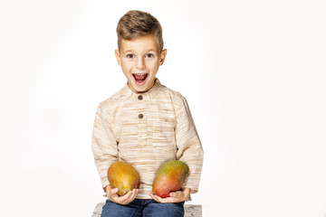 Fototapeta premium handsome pretty boy is holding a mango 