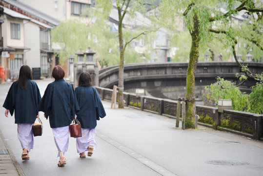 Japanese Woman Family Wearing Kimono And Walking At Kinosaki Onsen Village Street In Toyooka City, Hyogo, Japan. See From Back Side In Morning. Japan Traveler Trip.