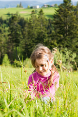 Girl on a flowering meadow.