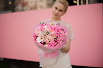 Girl with the bouquet of pink flowers