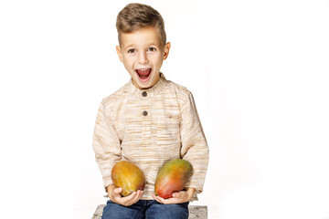 Fototapeta premium handsome pretty boy is holding a mango 