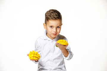 handsome boy in a white shirt with a mango