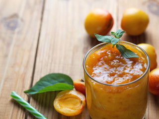 Summer delicious Apricot smoothie in a glass on a wooden background