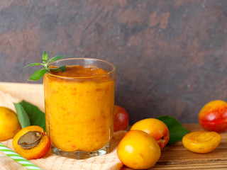 Summer delicious Apricot smoothie in a glass on a wooden background