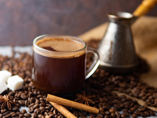 Espresso transparent glass Cup and coffee beans on the table .