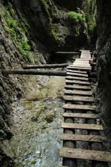 Dangerous trail through a waterfall with wooden ladders in the Slovak Paradise National Park, Slovaki