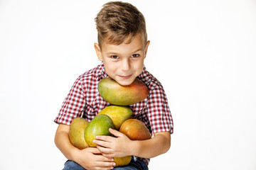 Fototapeta premium handsome boy in a red shirt with a mango