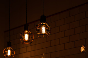 Vintage pendant light bulbs Edison on a dark background. Сoncept of creativity. Old vintage light...