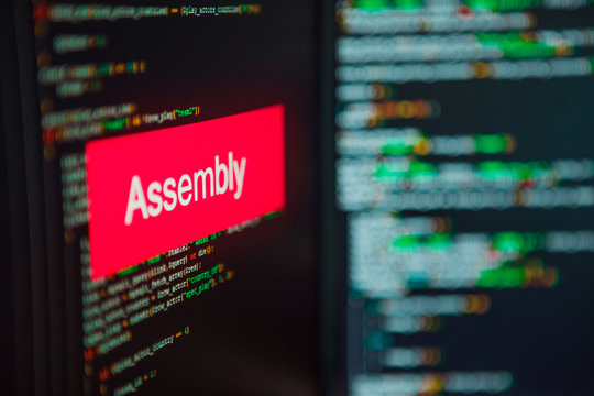 Programming language, Assembly inscription on the background of computer code.