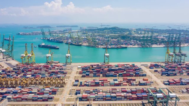 aerial view hyperlapse 4k video of busiest Asian cargo port with hundreds of ships loading export and import goods and thousands of containers in harbor singapore.