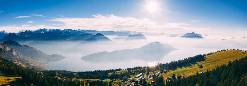 panoramic drone view over snow covered mountains during autumn, aerial view over swiss alps with lake in fog covered, rigi switzerland