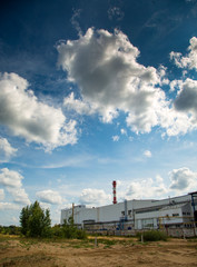 Clouds in the blue sky over the plant. Ecology, environment