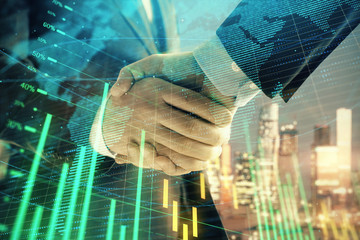 Double exposure of financial chart and world map on cityscape background with two businessmen handshake. Concept of international investment