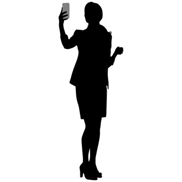 slim tall girl in short skirt and jacket makes selfie with smartphone