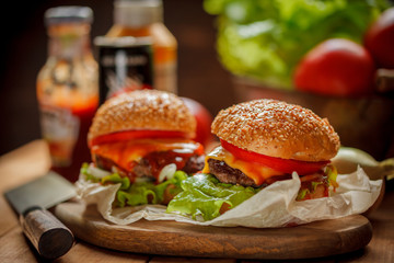cheeseburgers, burgers with tomatoes, cheese, salad and tomato sauce