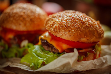 cheeseburgers, burgers with tomatoes, cheese, salad and tomato sauce