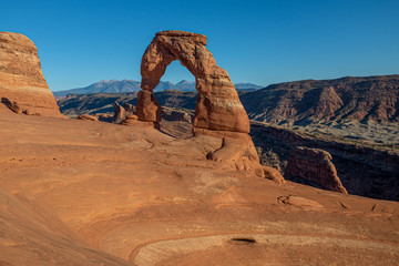 A landscape shot of the beautiful Delicate Arch at dusk at Arches National Park