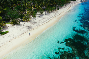 Man standing on the beach and enjoying the tropical place with a view. caribbean sea colors and...