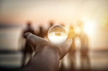 Artistic portrait of friends with reflection inside a glass sphere