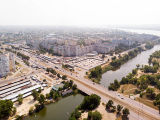 Aerial photography of a cityscape with a river with bridge, a road and a buildings.