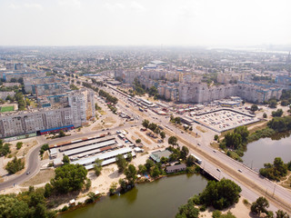 Aerial photography of a cityscape with a river with bridge, a road and a buildings.