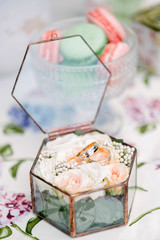 Still life brides morning, dish with cup of tea, champagne glass, wedding rings and flower bouquet