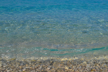 Obraz premium Pebbles under water. Marine background. Pure sea water. Clear sea