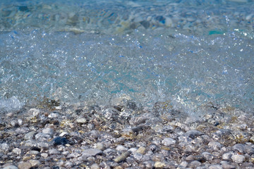 Pebbles under water. Marine background. Pure sea water. Clear sea