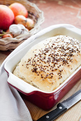 Homemade wheat bread with flax seeds in ceramic baking dish