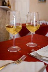 Wine Glass of white wine on the table in a restaurant outside over blurred background
