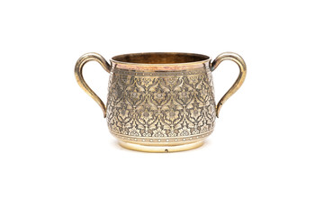 Old silver sugar bowl without a lid on a white background.